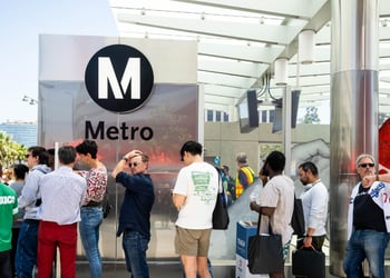 People standing next to LA Metro