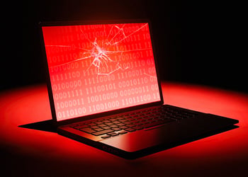 laptop with a broken glass, red, black background