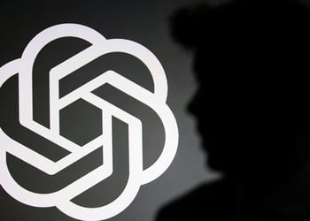 The silhouette of Sam Altman and OpenAI logo