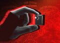 shadowy hand holds black chip, china stars on it, red background,