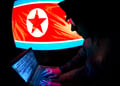 north korean hacker, flag on screen, military hat, open laptop, blue screen, numbers