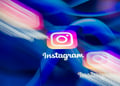 three instagram logos, two blurry, meta logos, the blue infinity signs, in the background