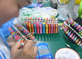 manicure, white chinese woman face, orange, pink, lemon green, yellow plastic nails.