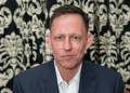 Peter Thiel, dark suit, white collar shirt, no tie, dark hair, light eyebrows, smirk