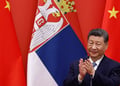 Xi Jinping, serbia flag, two china flags, black suit, white shirt, blue tie, black hair, claps, yellow stars