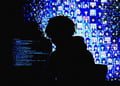 A silhouette of a hacker, hacking into an anime system.