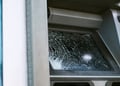 Broken glass ATM on street