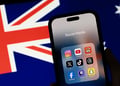 Logos of various social media apps on a phone screen next to Australian flag.